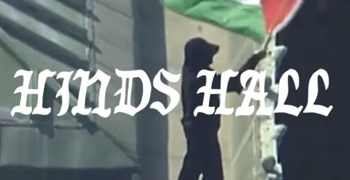 Hind's Hall by Macklemore photo of student on top of building with Palestine flag